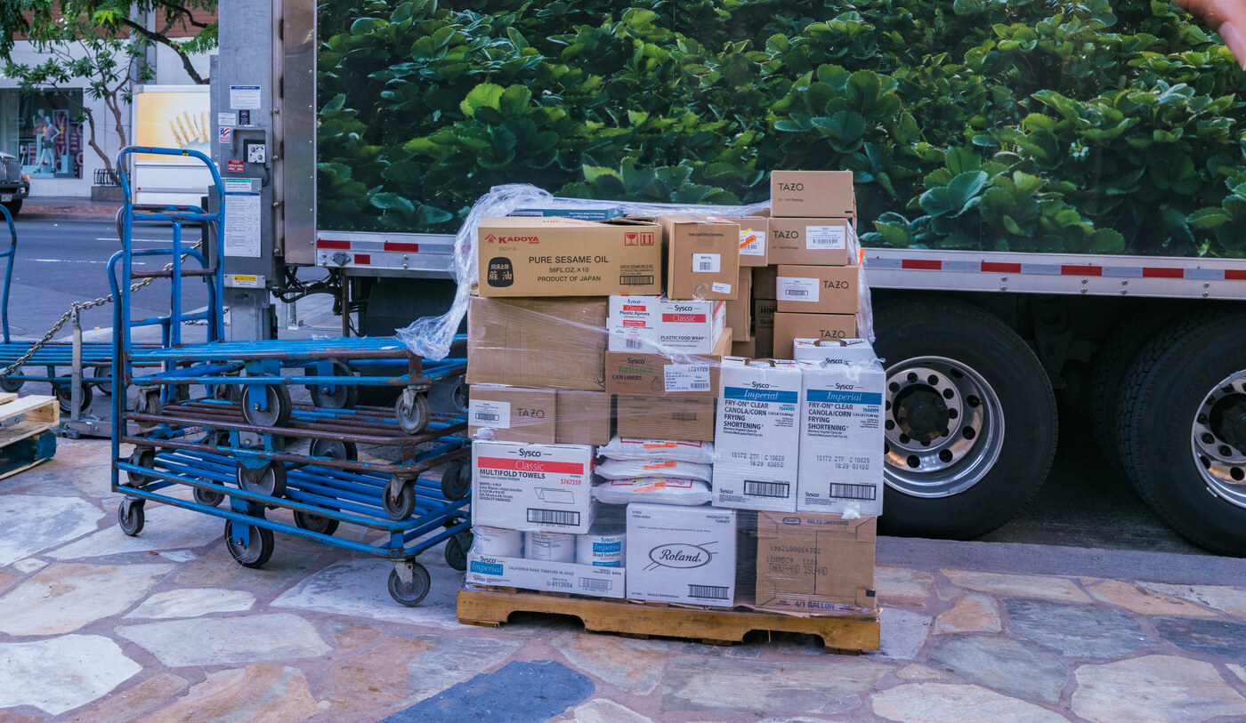 Stacked boxes on a pallet at a receiving location.