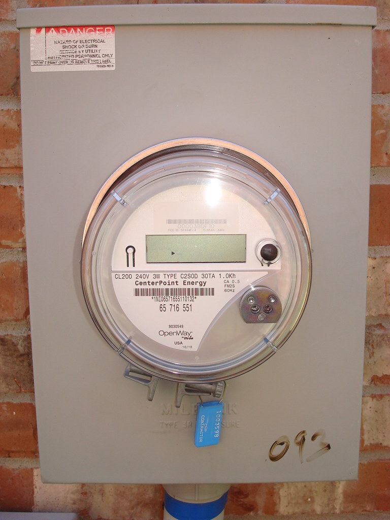 Installed electric meter photographed close-up for field-service documentation.